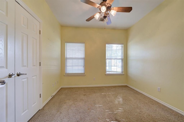 carpeted empty room with ceiling fan