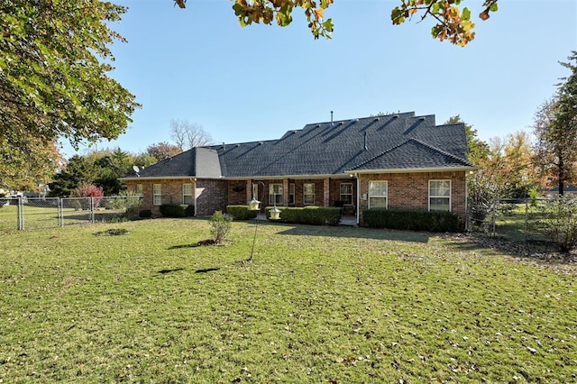 rear view of property with a yard