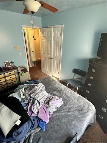 carpeted bedroom with a closet and ceiling fan