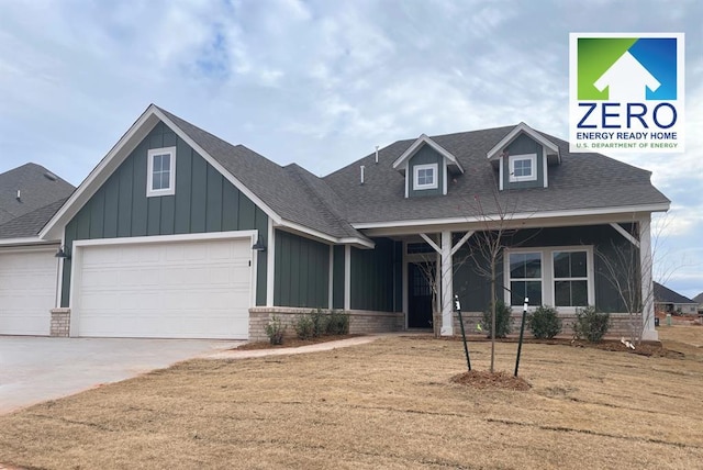 view of front of house with concrete driveway, brick siding, a front lawn, and roof with shingles