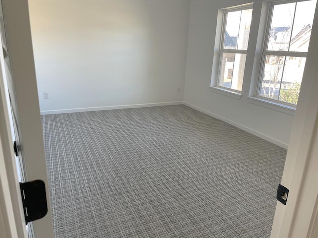 empty room with carpet floors and baseboards