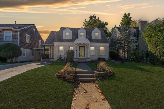 cape cod-style house with a yard