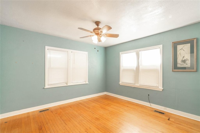 unfurnished room featuring ceiling fan and hardwood / wood-style flooring