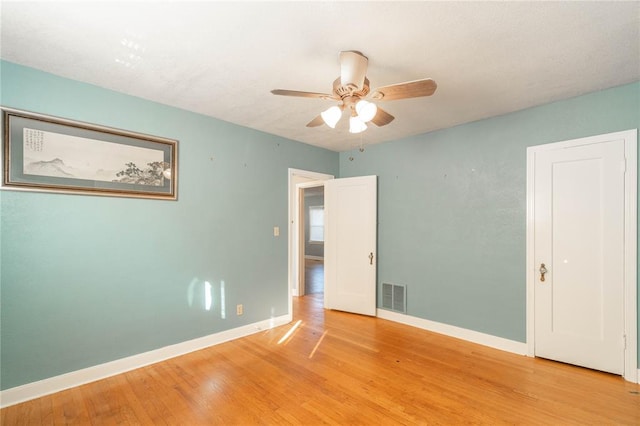 spare room featuring ceiling fan and light hardwood / wood-style flooring