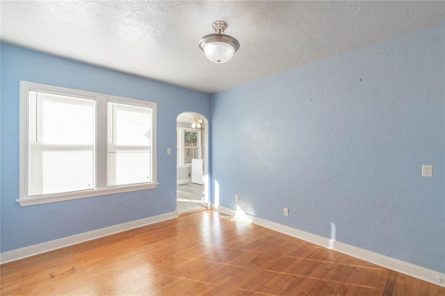 unfurnished room with light wood-type flooring