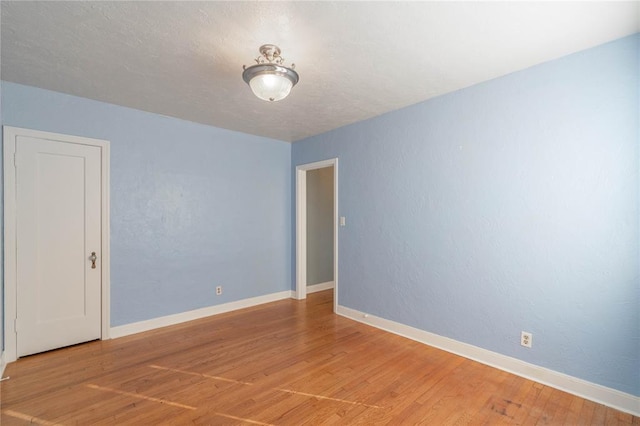 spare room with wood-type flooring