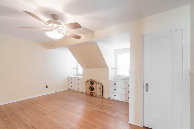 bonus room with ceiling fan, lofted ceiling, plenty of natural light, and light hardwood / wood-style flooring