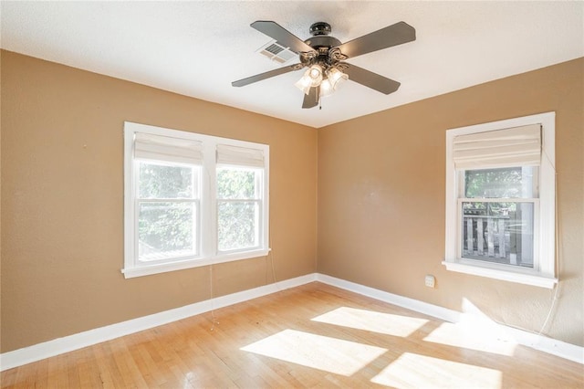 empty room featuring ceiling fan and light hardwood / wood-style floors