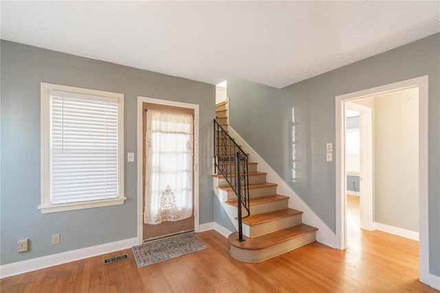 foyer entrance with light hardwood / wood-style floors