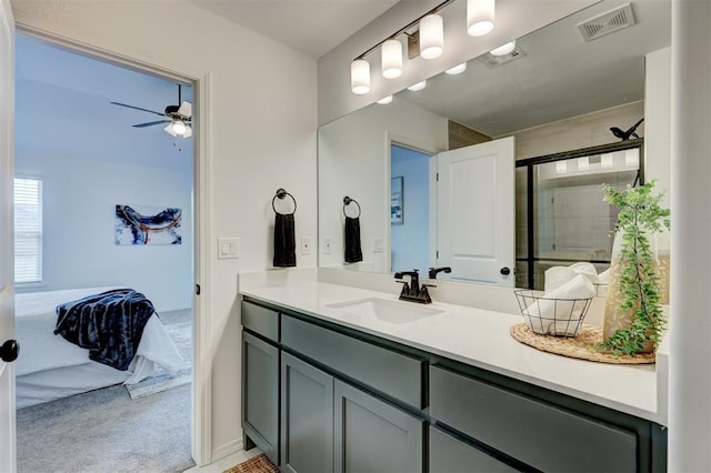 bathroom featuring ceiling fan, vanity, and an enclosed shower