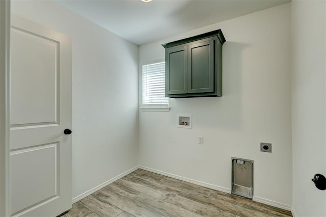 clothes washing area with hookup for an electric dryer, hookup for a washing machine, cabinets, and light wood-type flooring