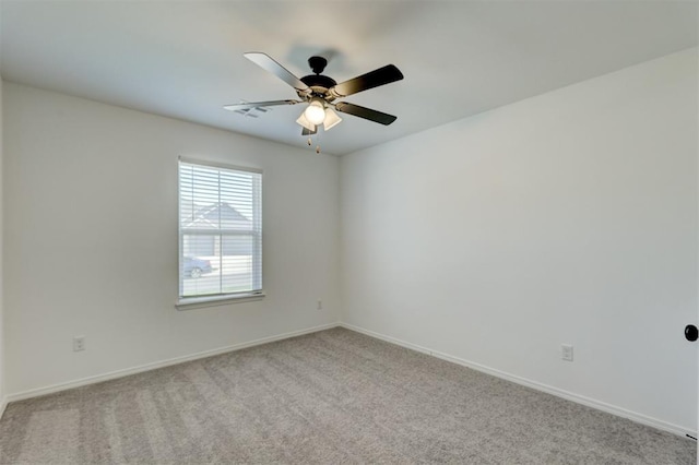 unfurnished room featuring ceiling fan and light carpet