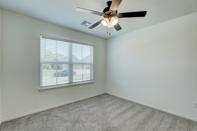 unfurnished room featuring light carpet, ceiling fan, and a healthy amount of sunlight