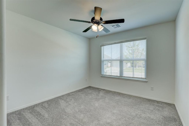 carpeted empty room featuring ceiling fan