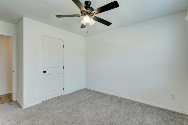 unfurnished bedroom with ceiling fan, a closet, and light colored carpet