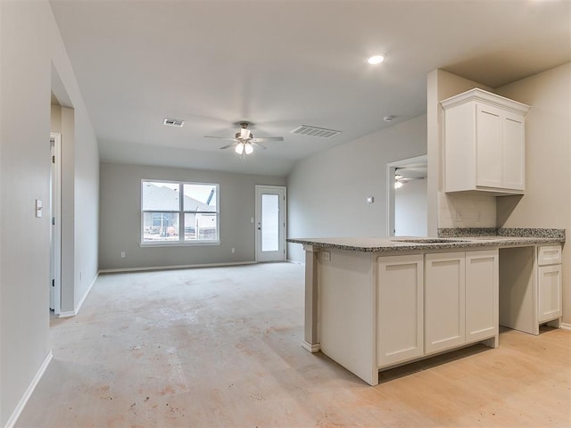 kitchen with ceiling fan, visible vents, and white cabinetry