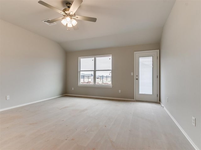 empty room with light wood finished floors, lofted ceiling, visible vents, a ceiling fan, and baseboards