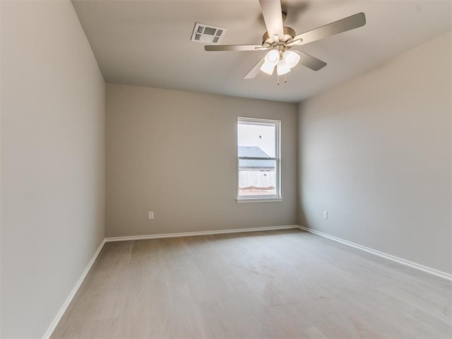 unfurnished room featuring ceiling fan, light wood-type flooring, visible vents, and baseboards