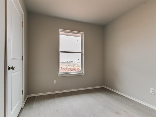 unfurnished room featuring light wood-style floors and baseboards