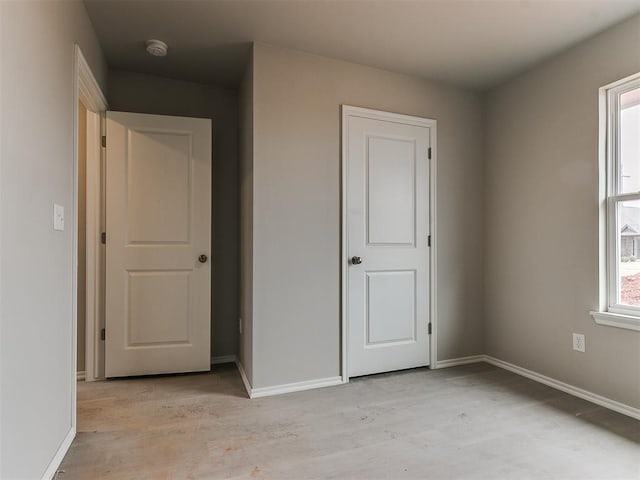 unfurnished bedroom featuring baseboards and light wood-style floors