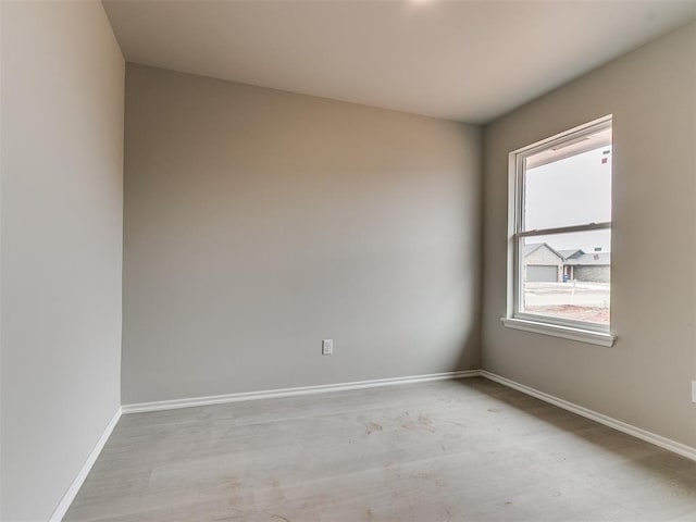 spare room featuring baseboards