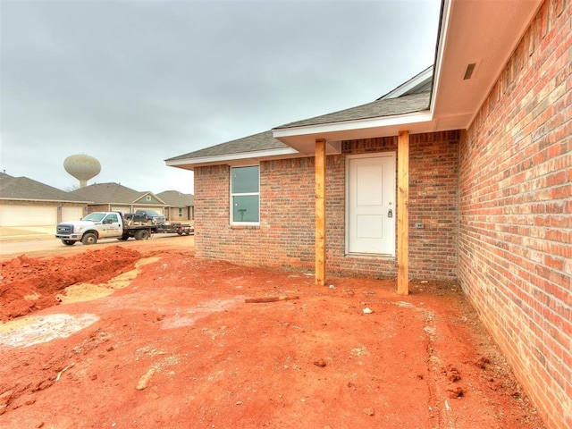 entrance to property featuring brick siding