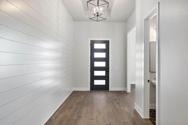 foyer with dark hardwood / wood-style floors and an inviting chandelier