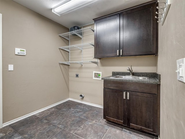 laundry room with washer hookup, cabinet space, a sink, electric dryer hookup, and baseboards