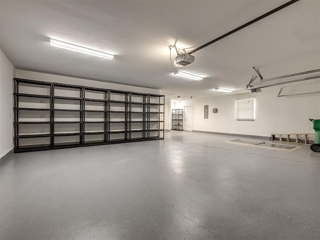 garage featuring electric panel and a garage door opener