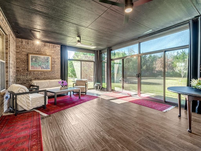 sunroom / solarium with a ceiling fan