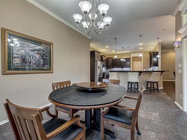 dining area with baseboards, a chandelier, stone tile flooring, and crown molding