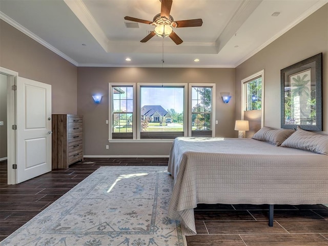 bedroom with wood tiled floor, ornamental molding, a raised ceiling, and baseboards