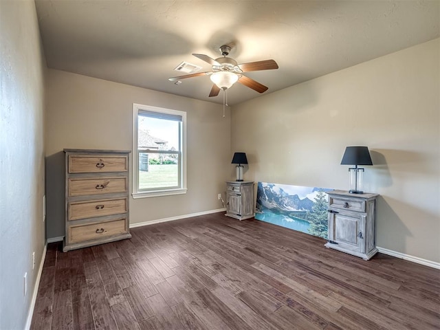 miscellaneous room featuring ceiling fan, dark wood-style flooring, visible vents, and baseboards