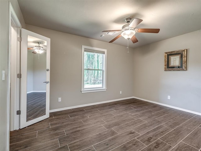 spare room with wood tiled floor, ceiling fan, and baseboards