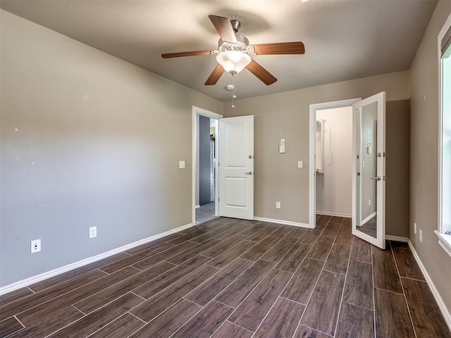 unfurnished bedroom with wood tiled floor, baseboards, and ceiling fan