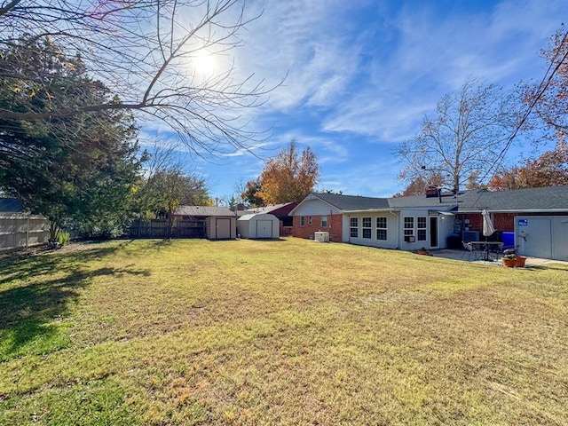 view of yard with a patio and a storage shed