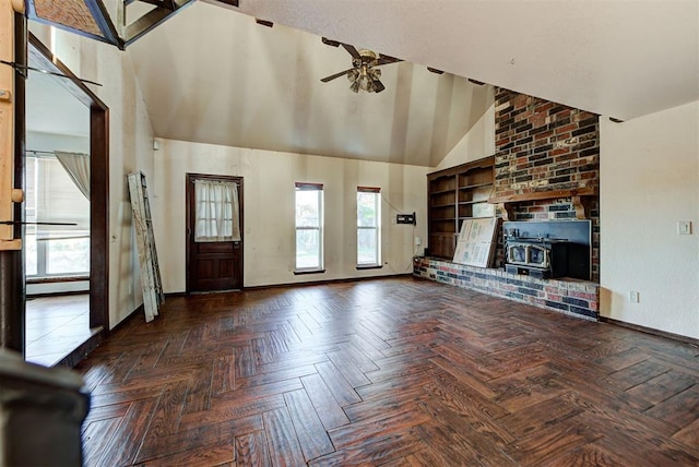 unfurnished living room with parquet flooring, high vaulted ceiling, a wood stove, and ceiling fan