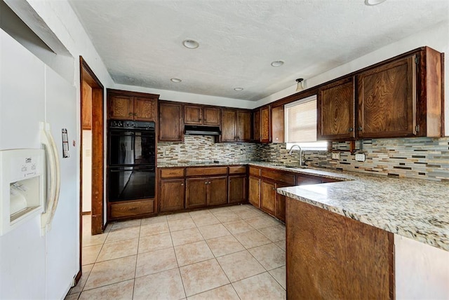 kitchen with decorative backsplash, black double oven, sink, white fridge with ice dispenser, and light tile patterned flooring