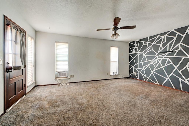 empty room with a textured ceiling, carpet floors, and ceiling fan