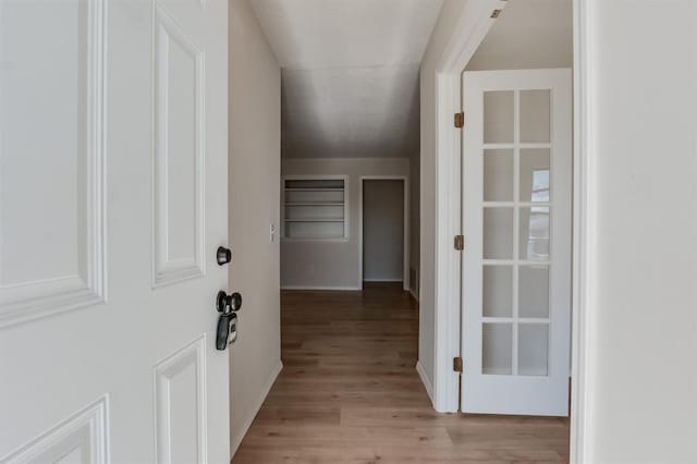 hallway with light wood-type flooring