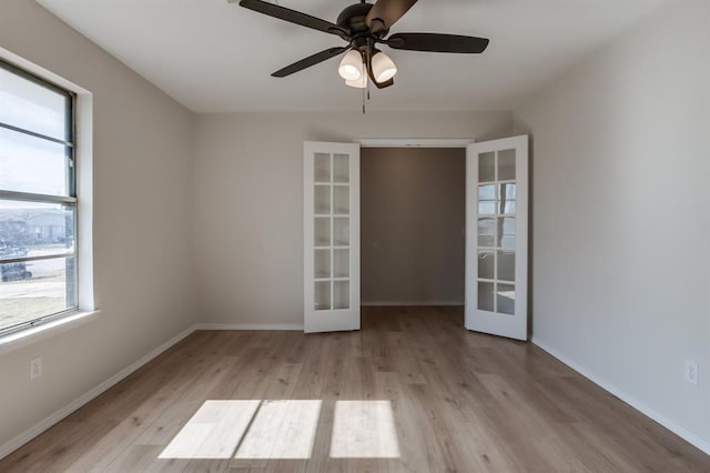 unfurnished room with french doors, plenty of natural light, and light wood-type flooring