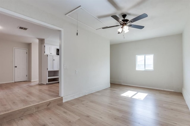 empty room featuring ceiling fan and light hardwood / wood-style flooring