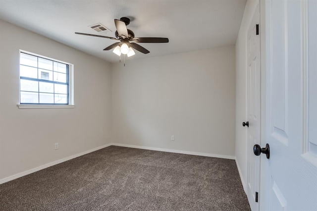 carpeted spare room with ceiling fan