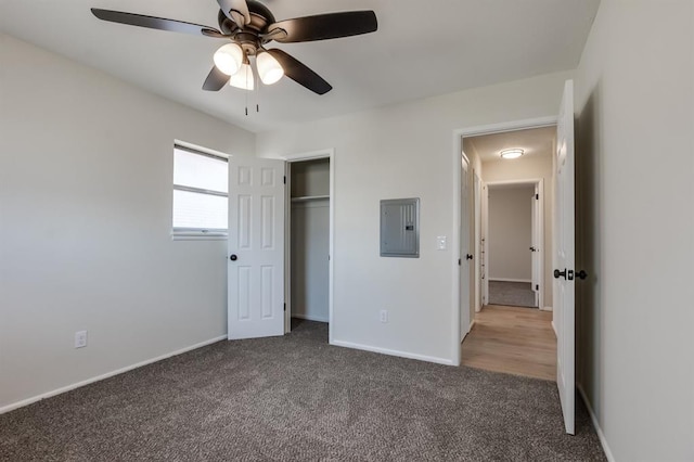 unfurnished bedroom featuring carpet flooring, electric panel, ceiling fan, and a closet