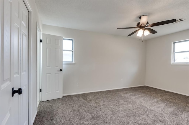 carpeted spare room with ceiling fan