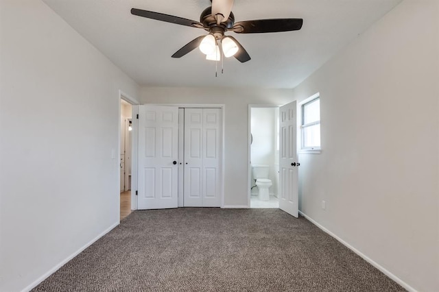 unfurnished bedroom with ensuite bathroom, carpet flooring, ceiling fan, and a closet