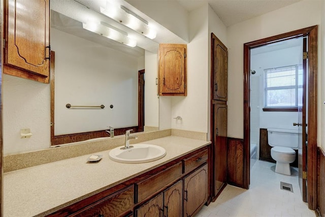 bathroom with tile patterned flooring, vanity, and toilet