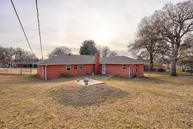 back of house featuring a yard and a patio