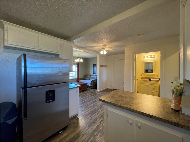 kitchen featuring stainless steel refrigerator, white cabinetry, dark hardwood / wood-style flooring, a textured ceiling, and ceiling fan with notable chandelier