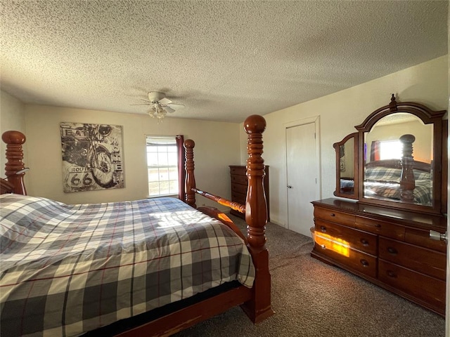 carpeted bedroom with ceiling fan and a textured ceiling